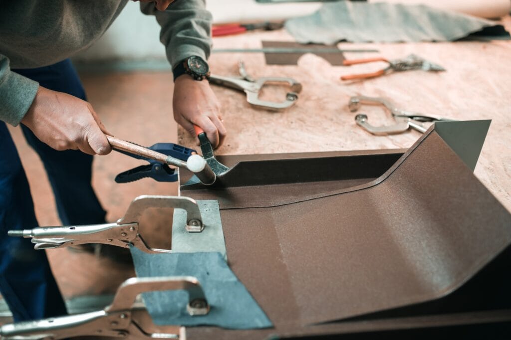 close up of a Worker hands use scissors to cut the metal sheet