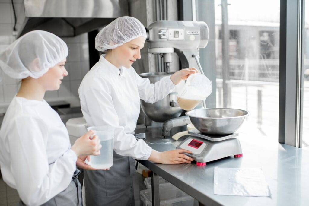 Confectioners working at the bakery manufacturing