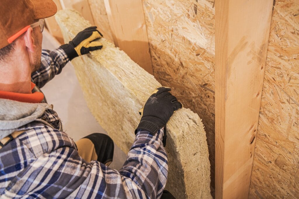 Contractor Installing Mineral Wool Insulator