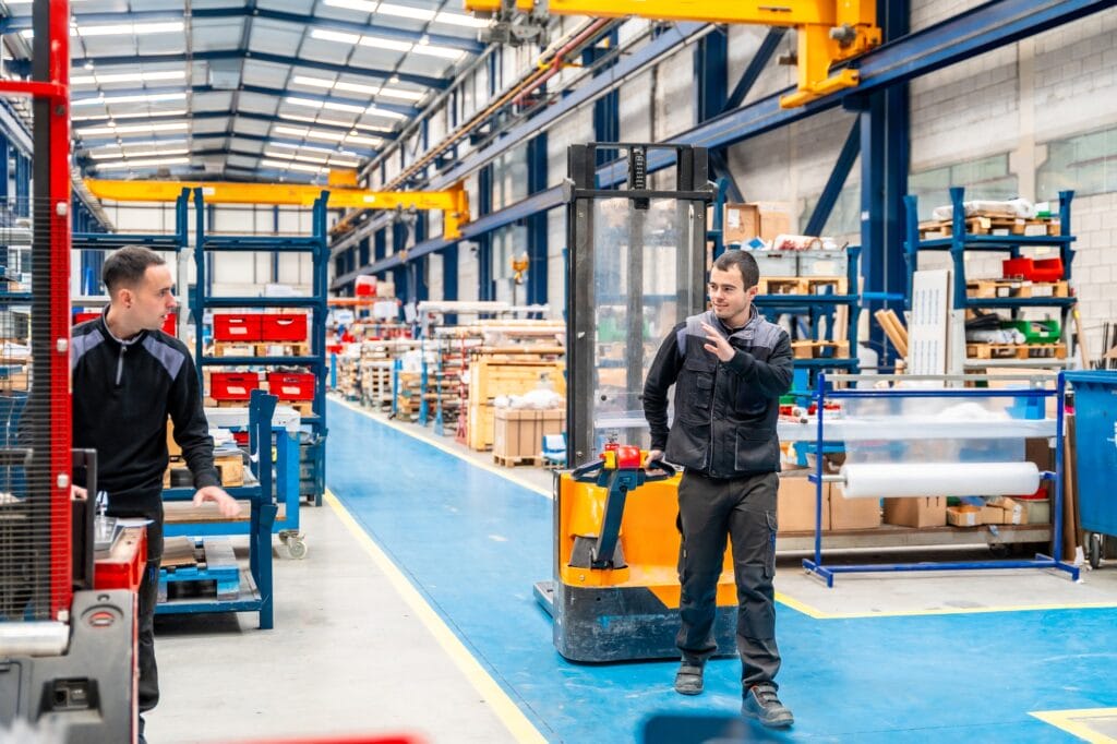 Coworkers using handcart in a logistic center