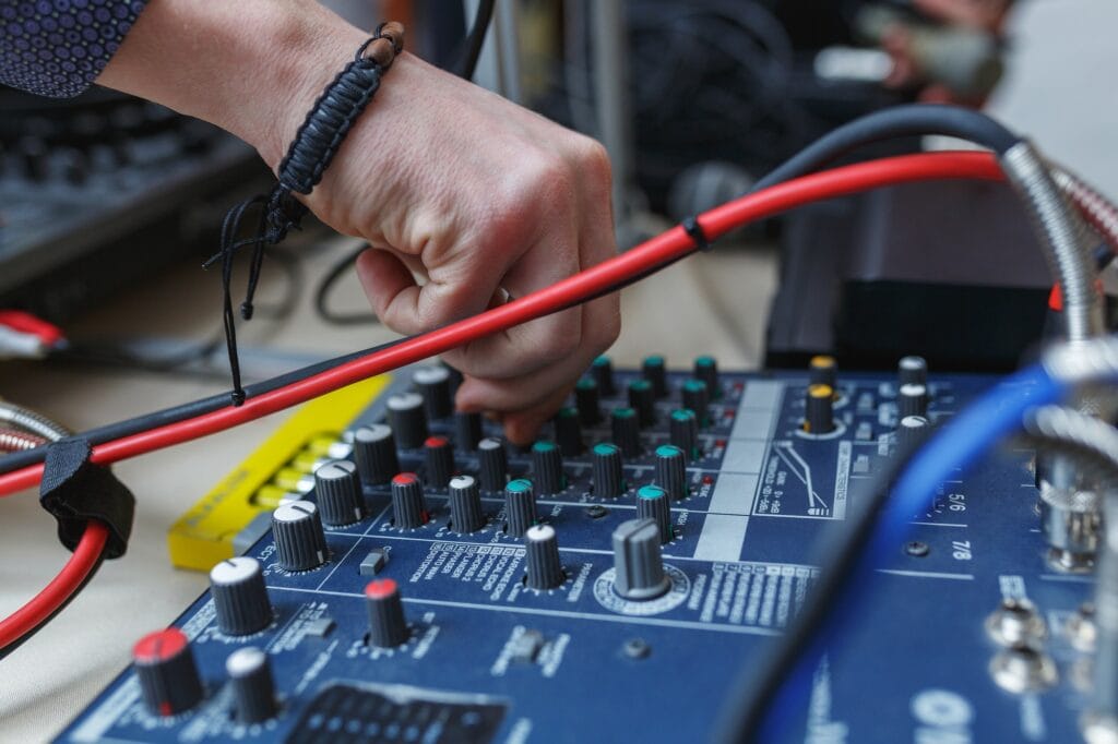 Man sets the audio level on the console audio effects.
