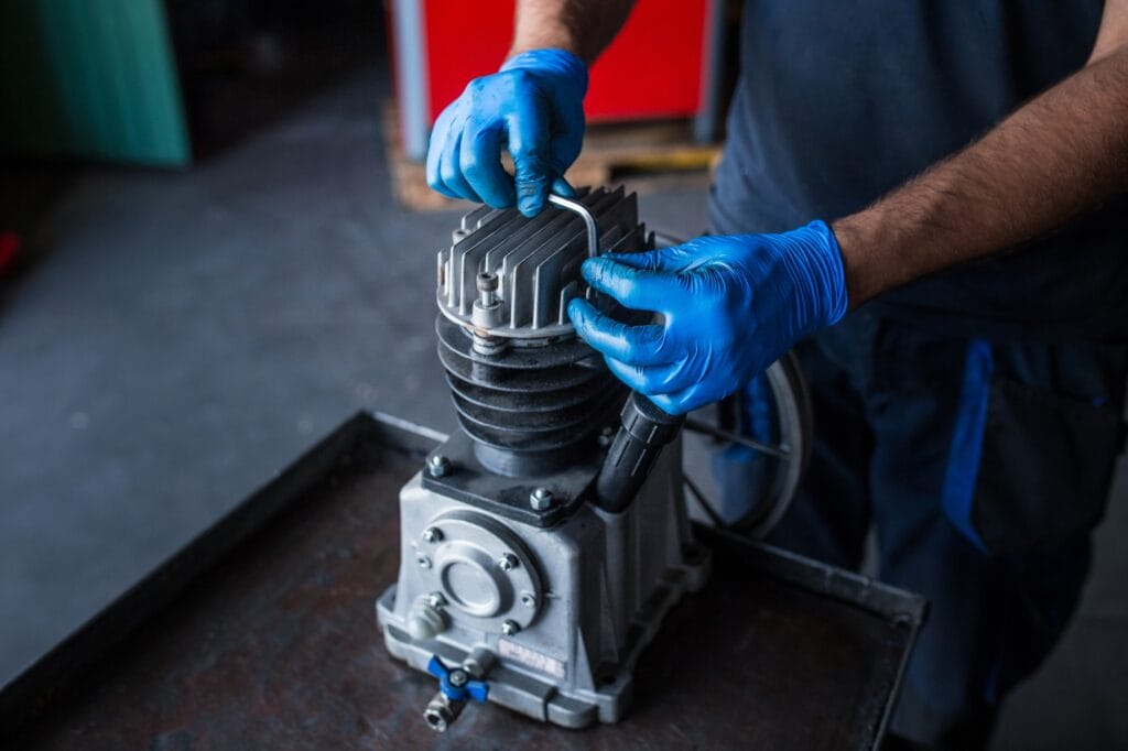 Mechanic fixing a compressor engine
