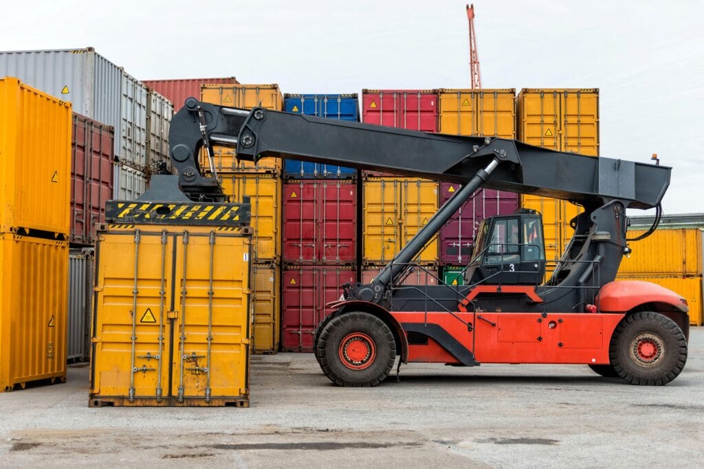 Mobile stacker handler in action at a container terminal.