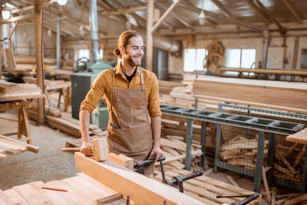 Portrait of a handsome carpenter at the joiner's shop