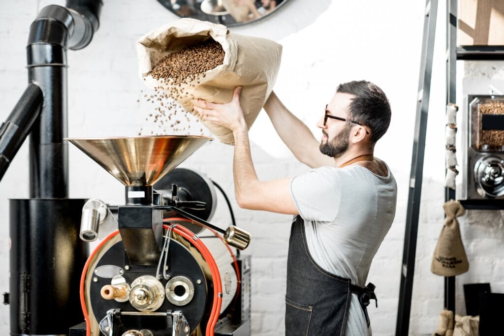 Pouring coffee into the roaster machine