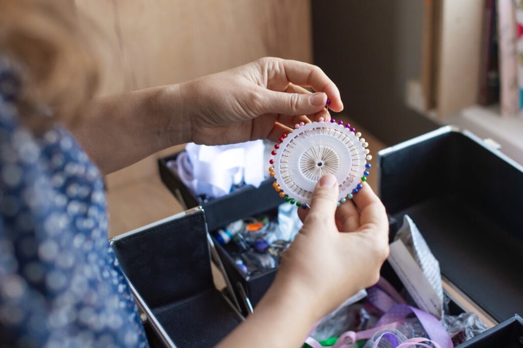 Handicraft Enthusiast Organizing Sewing Pins and Supplies